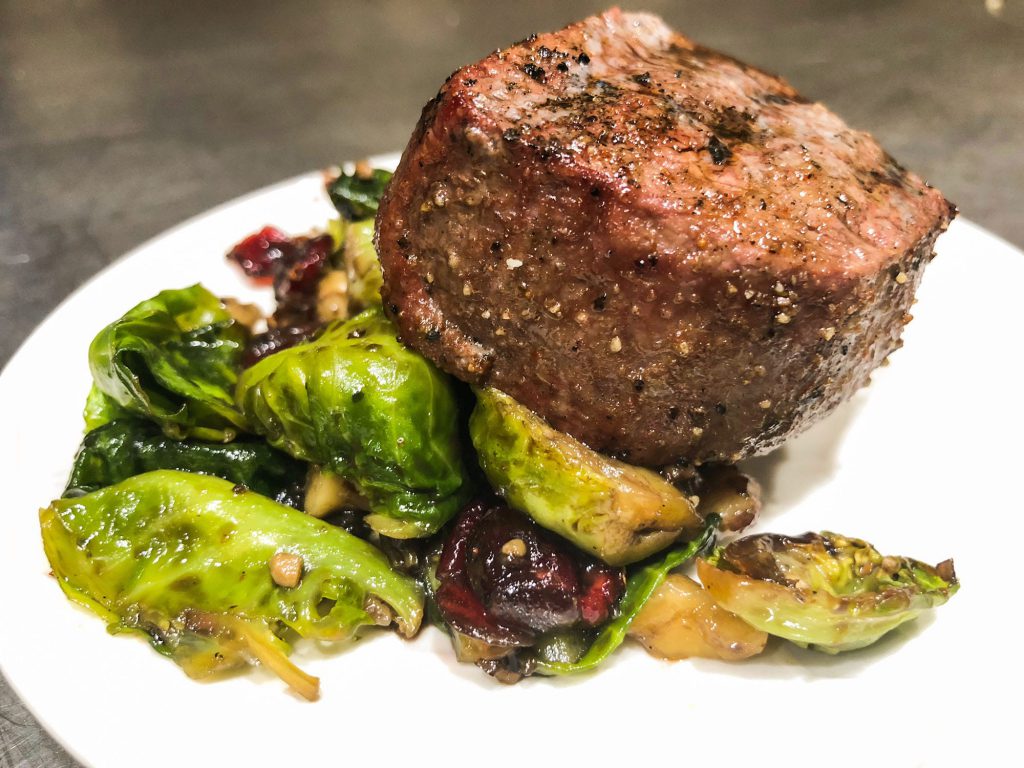 Seasoned steak and brussel sprouts on a plate
